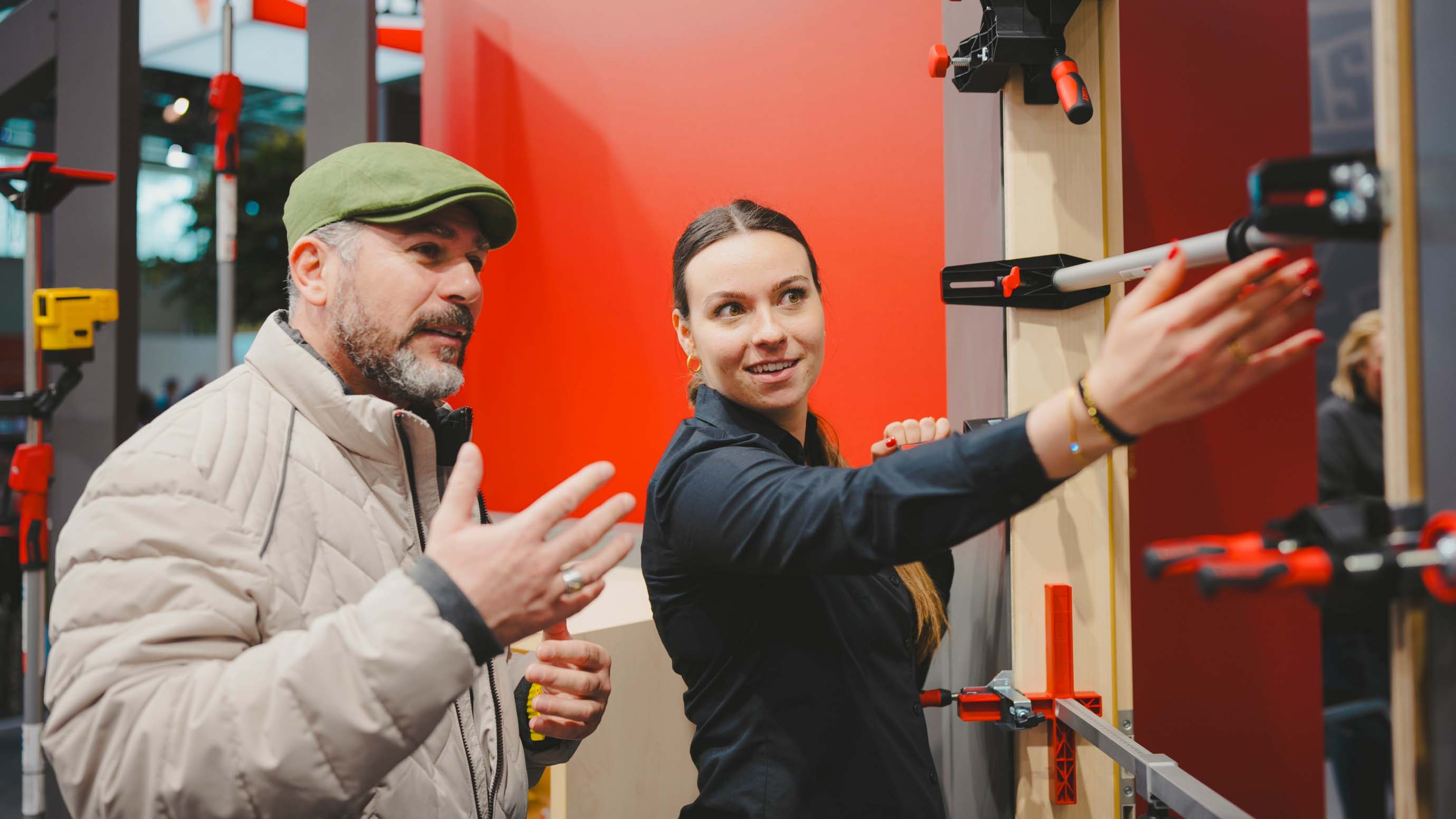 A man and a lady looking at a woodwork measuring machine